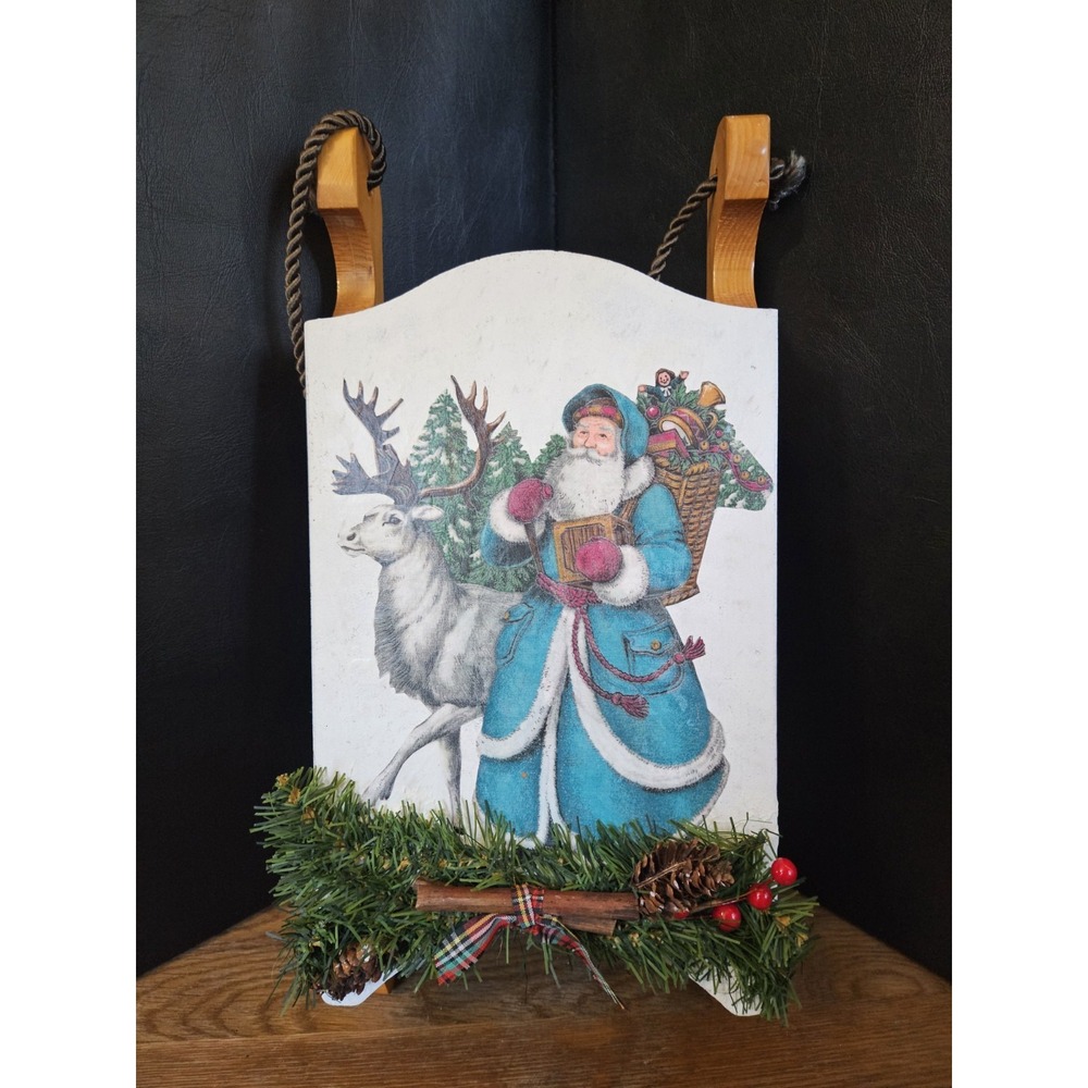 decorative wooden sled wall hanging features a blue-suited Father Christmas